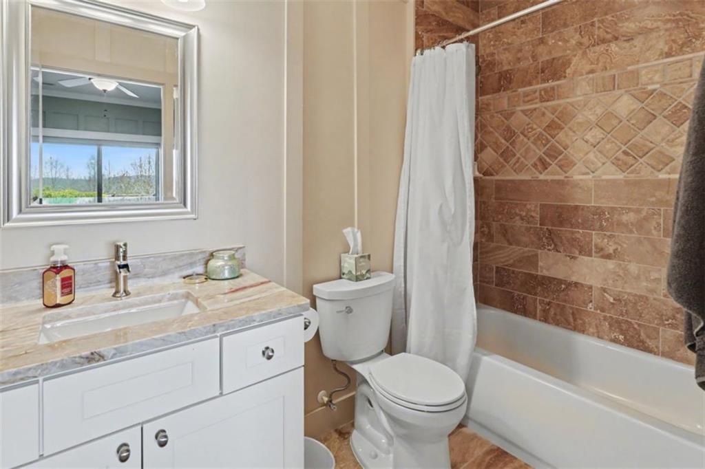 899 Ridge Pointe Way Blairsville, GA 30512 - Photo 52 of 88 a bathroom with a granite countertop toilet a sink and a bathtub