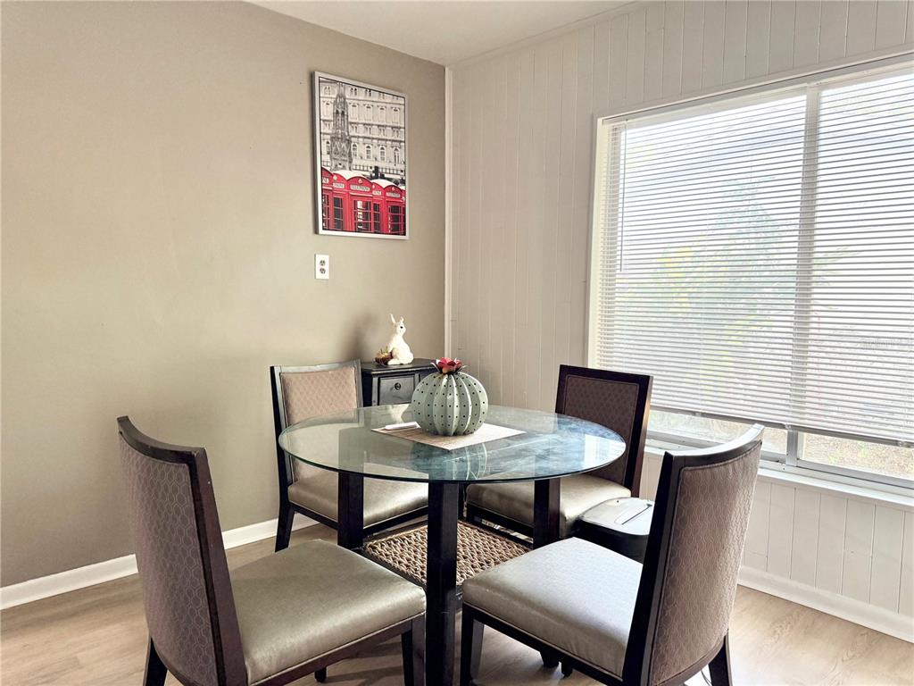 5846 Wyoming Avenue New Port Richey, FL 34652 - Photo 17 of 47 a view of a dining room with furniture and wooden floor