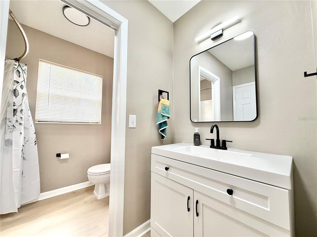 5846 Wyoming Avenue New Port Richey, FL 34652 - Photo 20 of 47 a bathroom with a toilet sink and mirror