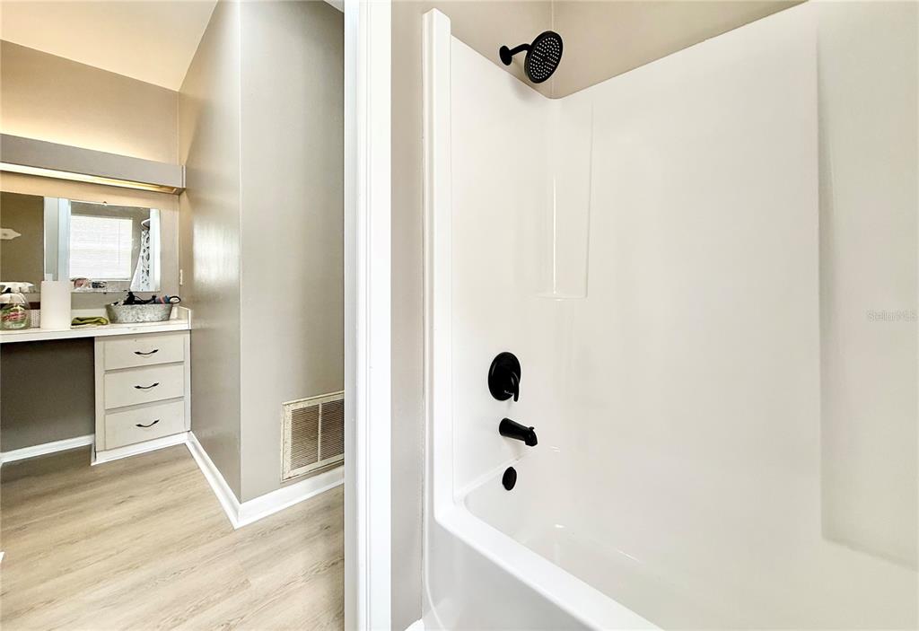 5846 Wyoming Avenue New Port Richey, FL 34652 - Photo 21 of 47 a bathroom with a bathtub sink and mirror