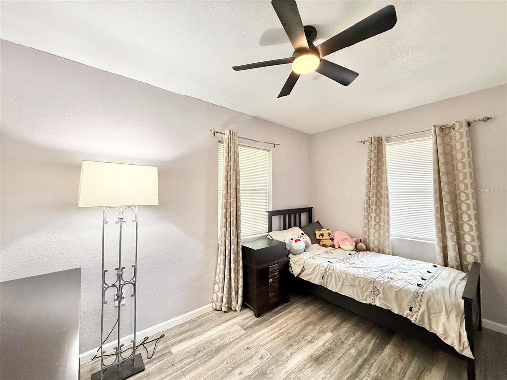 5846 Wyoming Avenue New Port Richey, FL 34652 - Photo 23 of 47 a bedroom with a bed and a lamp