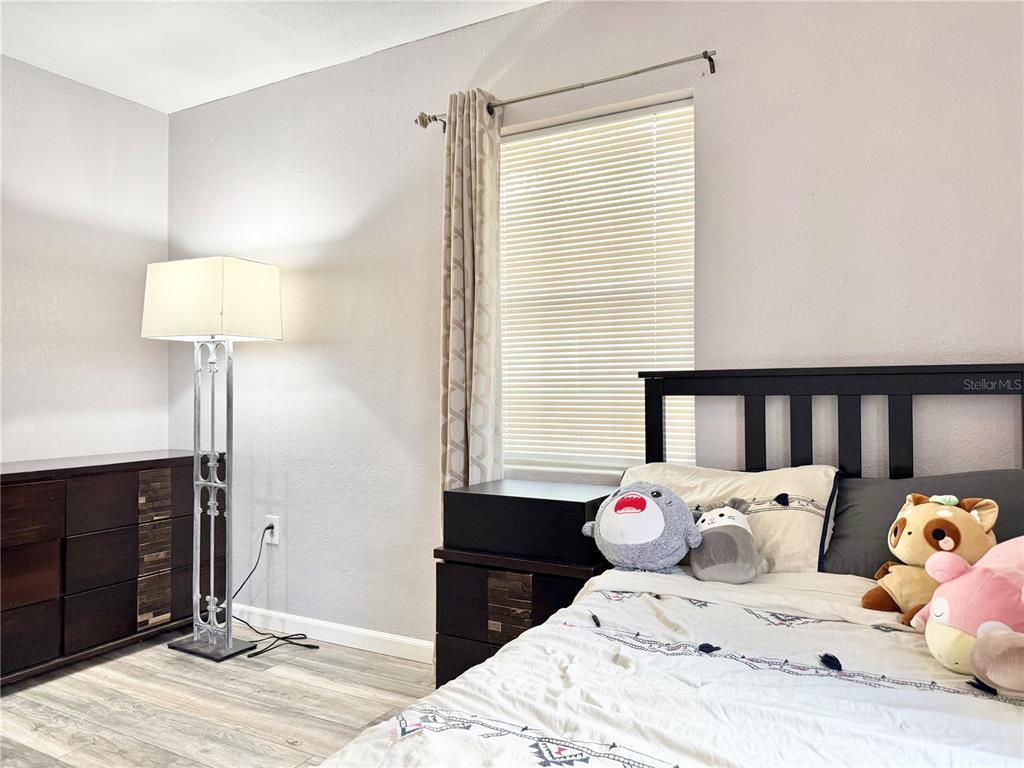 5846 Wyoming Avenue New Port Richey, FL 34652 - Photo 25 of 47 a bedroom with a bed and wooden floor