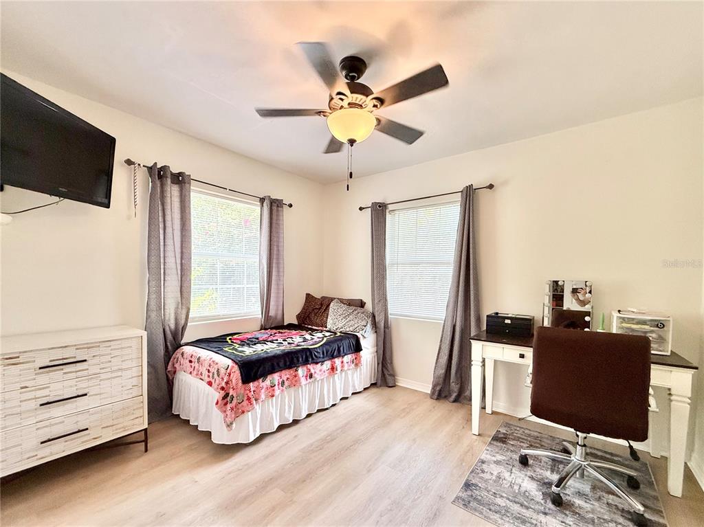5846 Wyoming Avenue New Port Richey, FL 34652 - Photo 29 of 47 a bedroom with a bed and flat screen tv