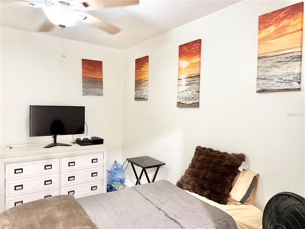 5846 Wyoming Avenue New Port Richey, FL 34652 - Photo 34 of 47 a bedroom with a bed and a flat screen tv