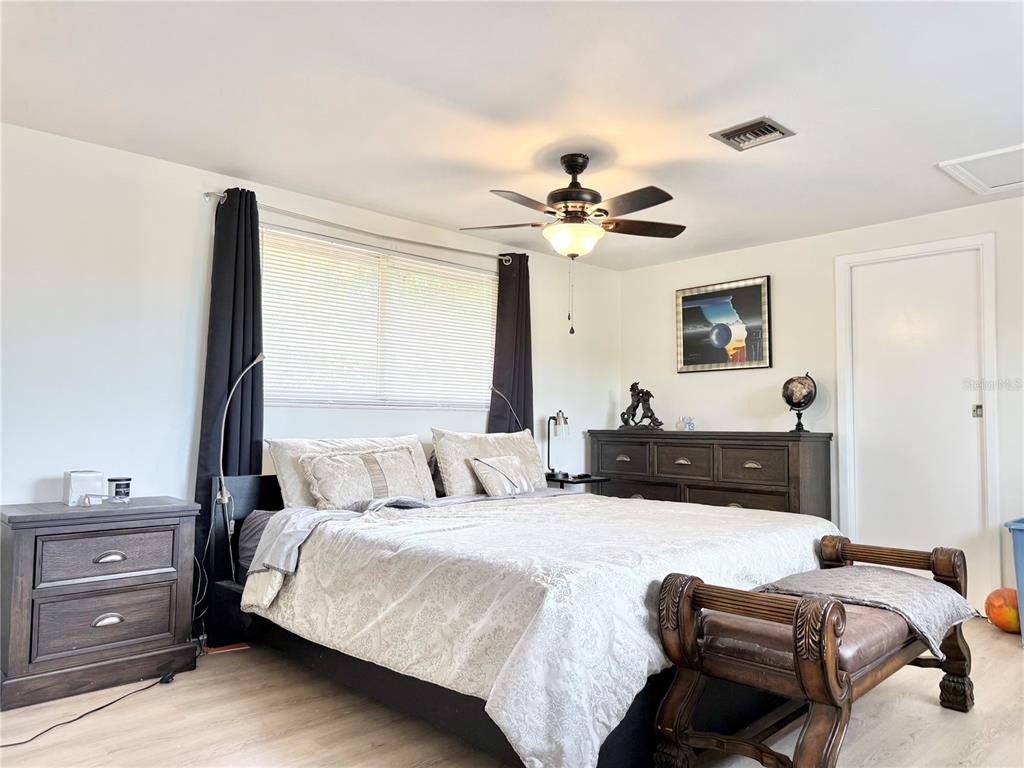 5846 Wyoming Avenue New Port Richey, FL 34652 - Photo 39 of 47 a bedroom with a bed and a chandelier