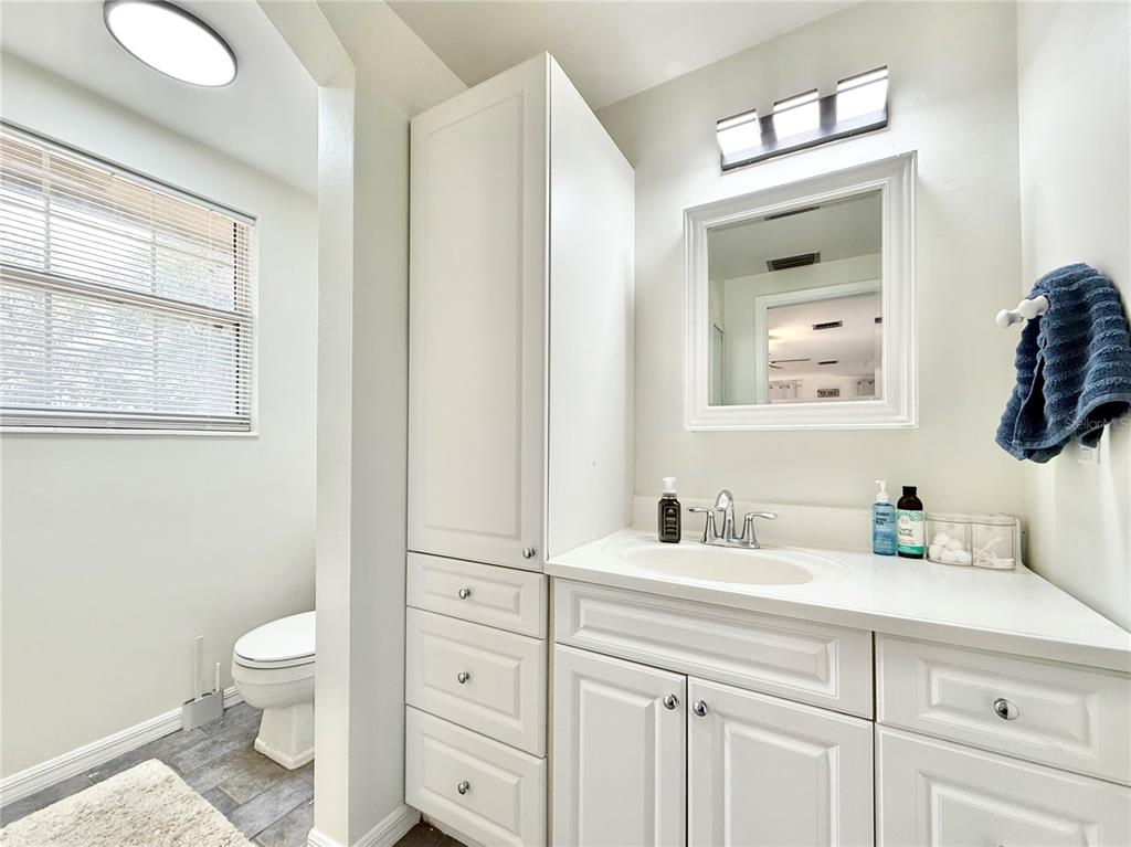 5846 Wyoming Avenue New Port Richey, FL 34652 - Photo 42 of 47 a bathroom with a toilet sink and mirror