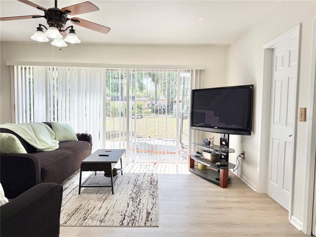 5846 Wyoming Avenue New Port Richey, FL 34652 - Photo 9 of 47 a living room with furniture and a flat screen tv