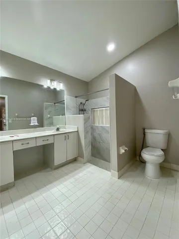 a bathroom with a sink mirror and toilet