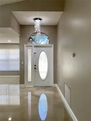 a view of a hallway with chandelier