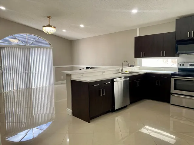 a kitchen with a sink and a stove