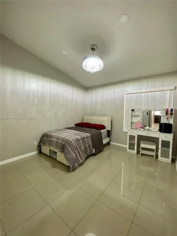 a bedroom with a bed and a table in it