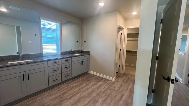 a bathroom with a granite countertop sink mirror and