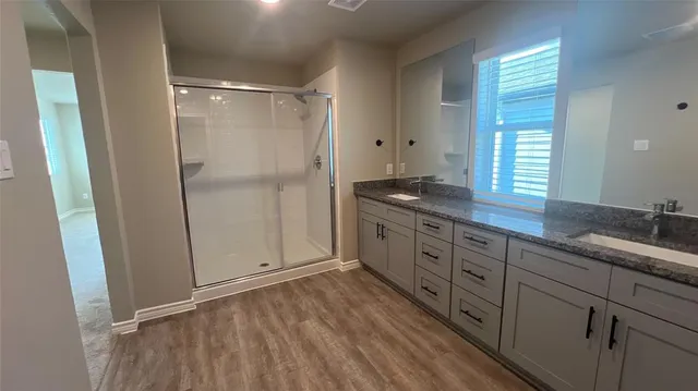 a spacious bathroom with a granite countertop sink mirror and double