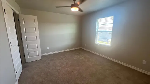 an empty room with windows and entrance