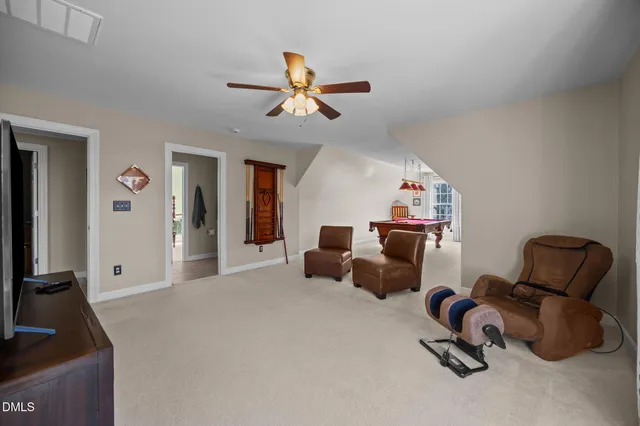 a living room with lots of furniture and a book shelf