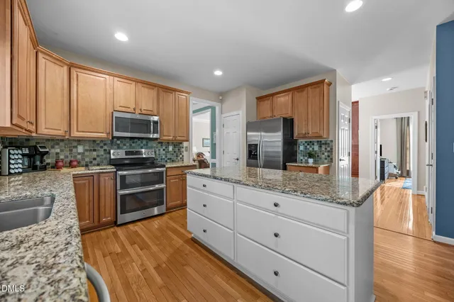 a living room with furniture ceiling fan and a large window