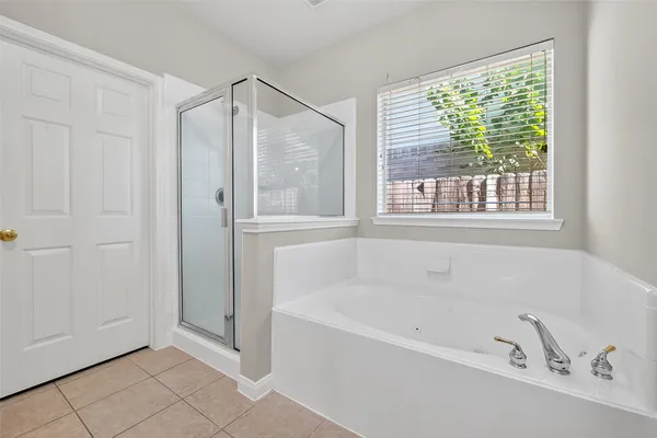 a bathroom with a granite countertop double vanity sink and a mirror