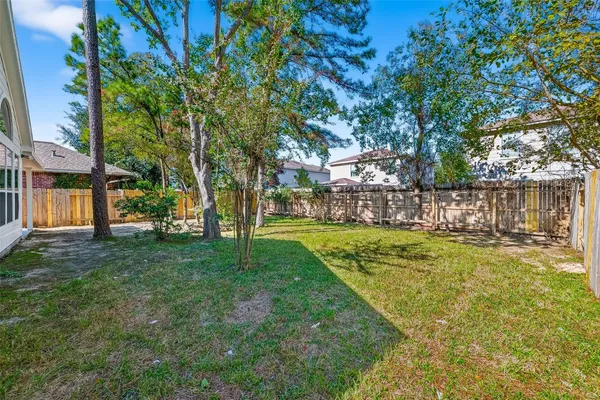 a view of a yard with a house in the background