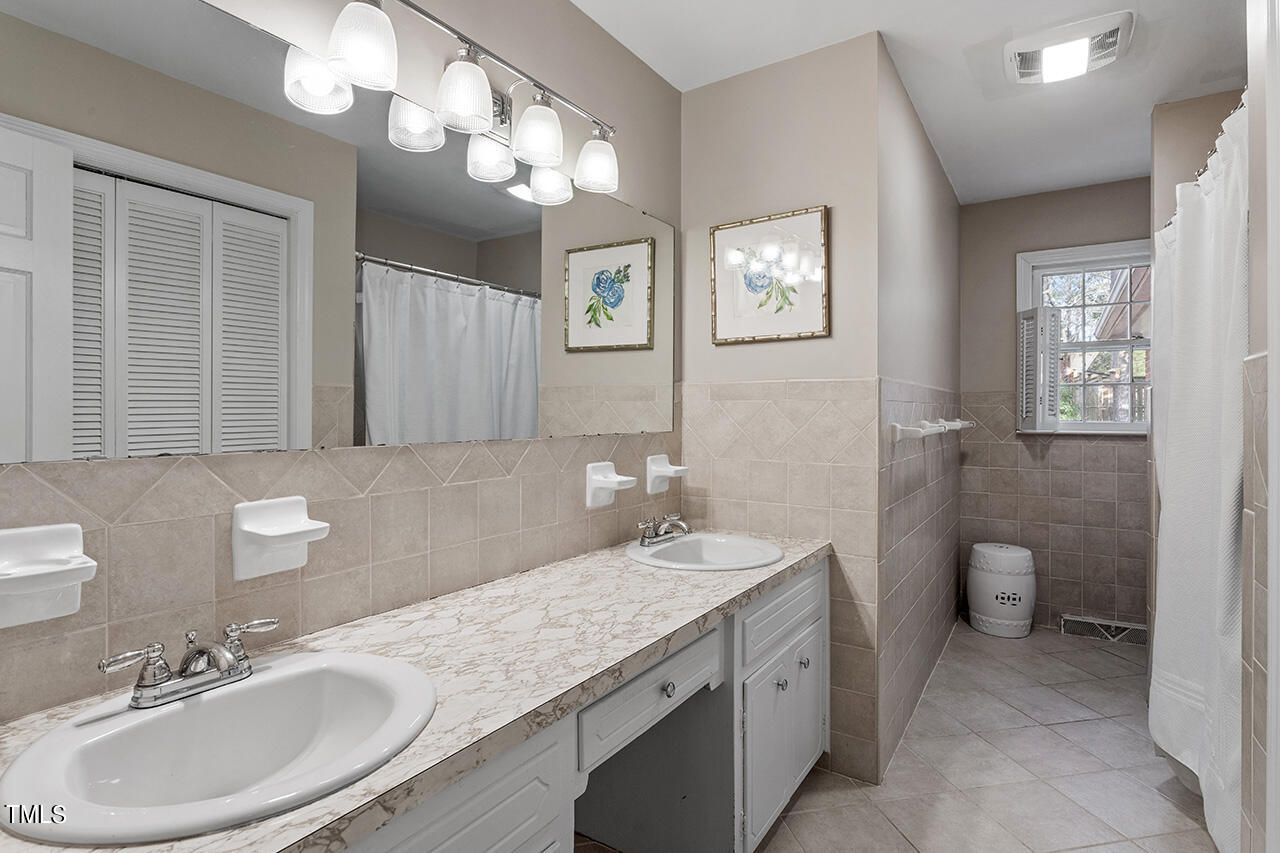 2010 Myron Drive Raleigh, NC 27607 - Photo 31 of 38 a bathroom with a sink a toilet and a mirror