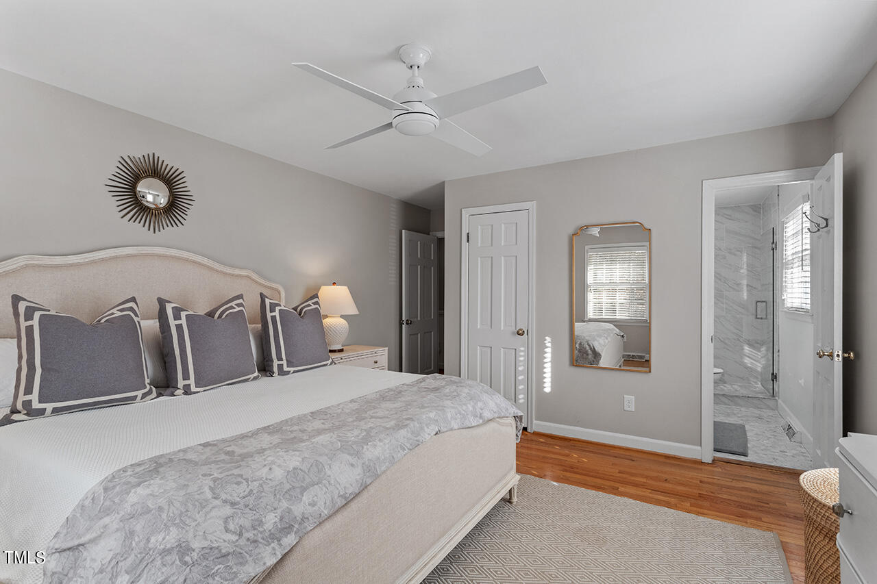 2010 Myron Drive Raleigh, NC 27607 - Photo 33 of 38 a bedroom with a large bed and chandelier