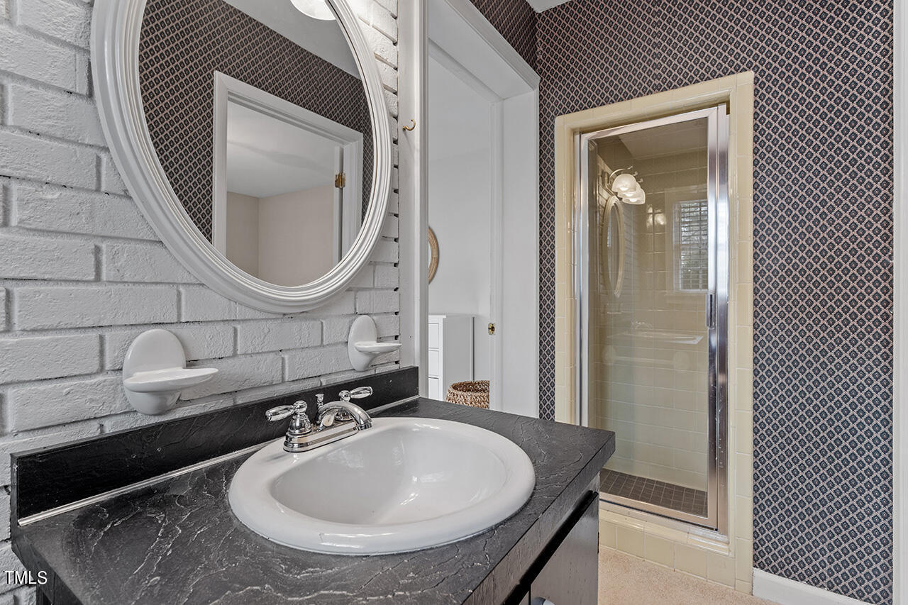 2010 Myron Drive Raleigh, NC 27607 - Photo 36 of 38 a bathroom with a sink and a mirror