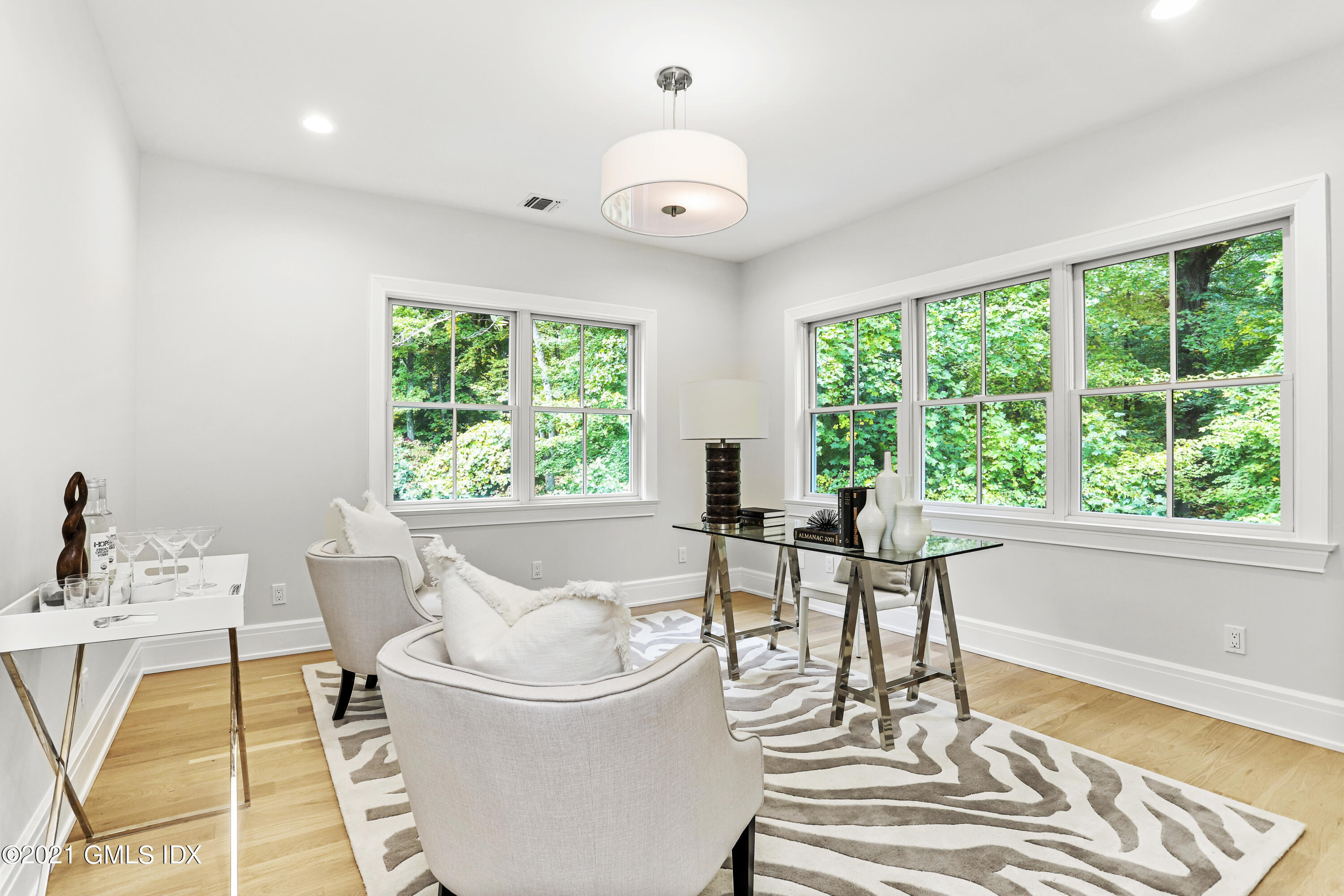633 Round Hill Road Greenwich, CT 06831 - Photo 14 of 26 a dining room with wooden floor a glass table and a large window