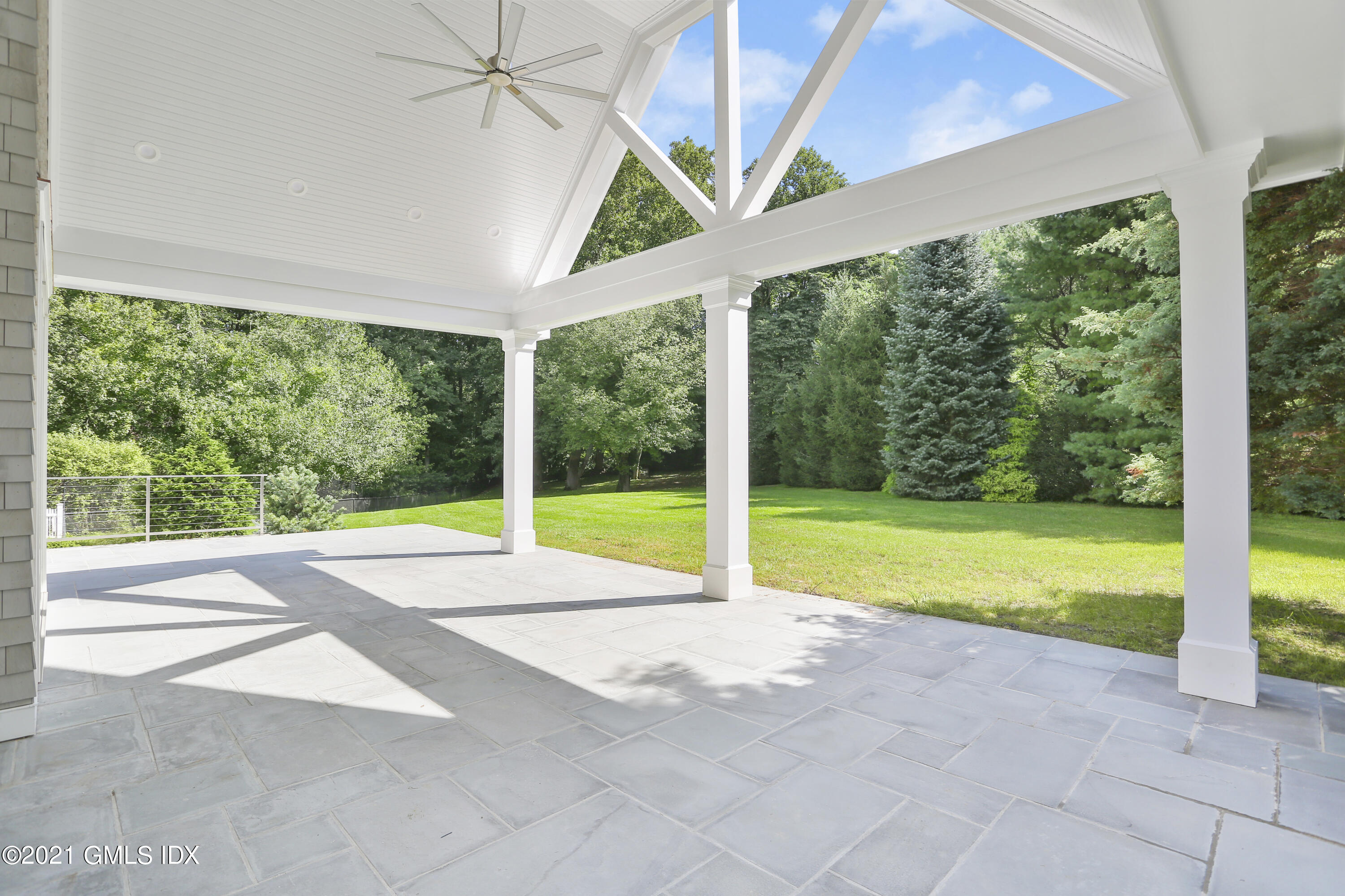 633 Round Hill Road Greenwich, CT 06831 - Photo 19 of 26 a view of an empty room with floor to ceiling windows and yard