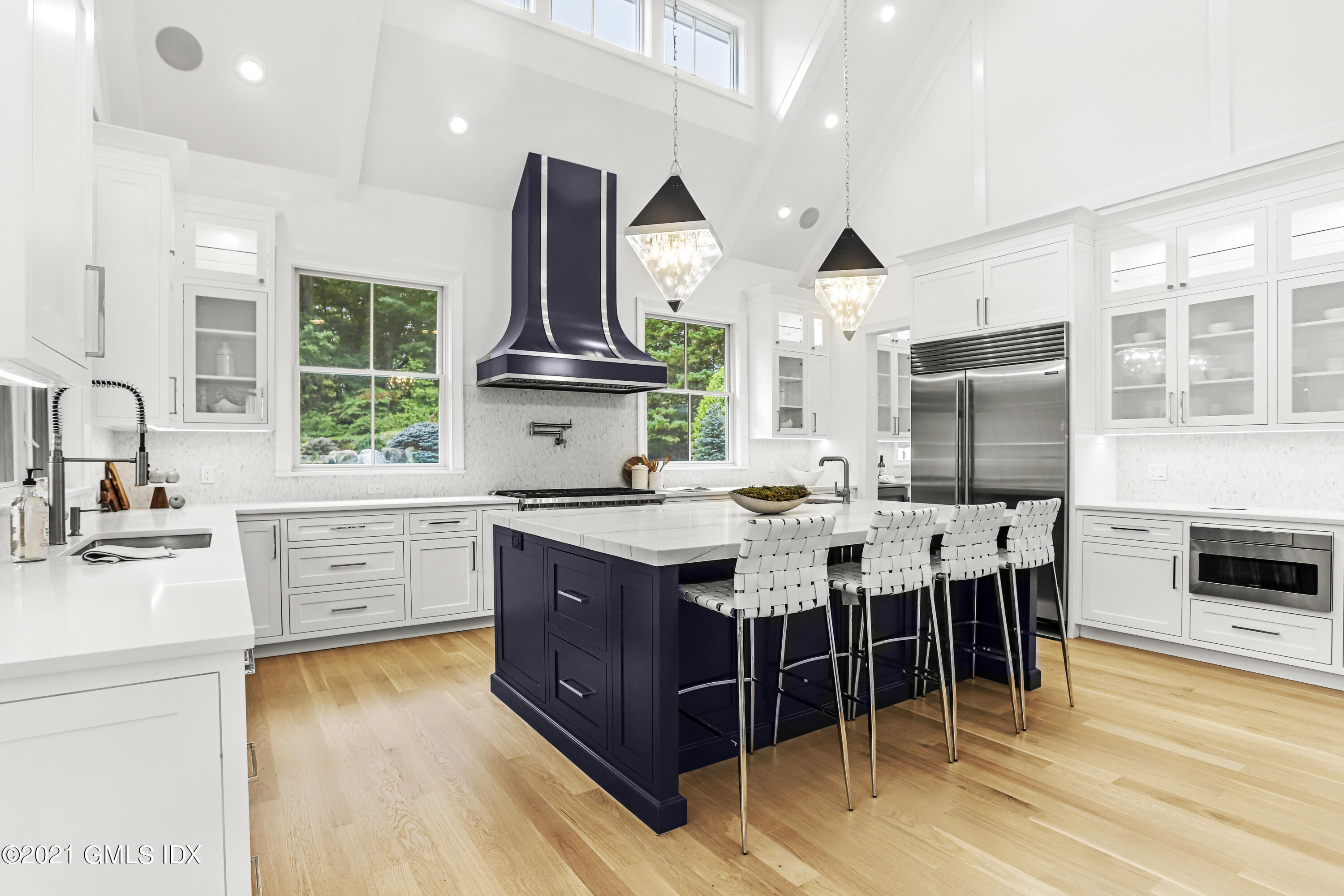 633 Round Hill Road Greenwich, CT 06831 - Photo 3 of 26 a kitchen with stainless steel appliances granite countertop a stove a sink dishwasher a oven a dining table and chairs with wooden floor
