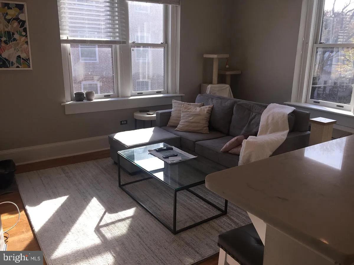 2410 20th Street Northwest, Unit 204 Washington, DC 20009 - Photo 2 of 8 a living room with furniture and a window