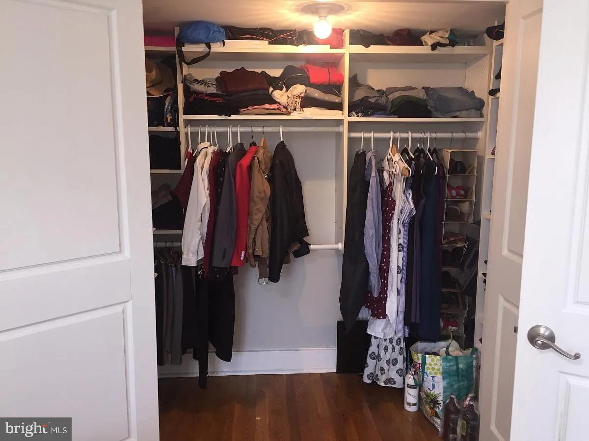 2410 20th Street Northwest, Unit 204 Washington, DC 20009 - Photo 6 of 8 a view of walk in closet with clothes and shoes