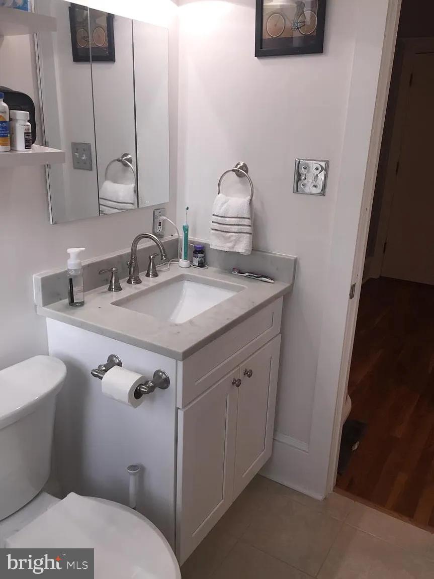 2410 20th Street Northwest, Unit 204 Washington, DC 20009 - Photo 7 of 8 a bathroom with a sink toilet and mirror