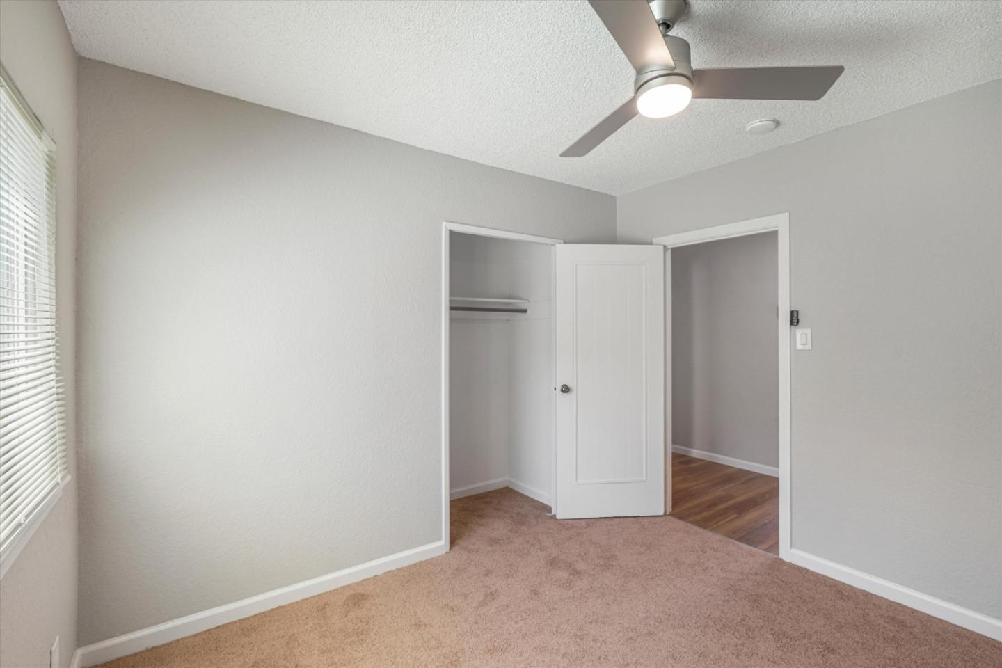 149 Covena Avenue Modesto, CA 95354 - Photo 12 of 24 an empty room with closet and a ceiling fan