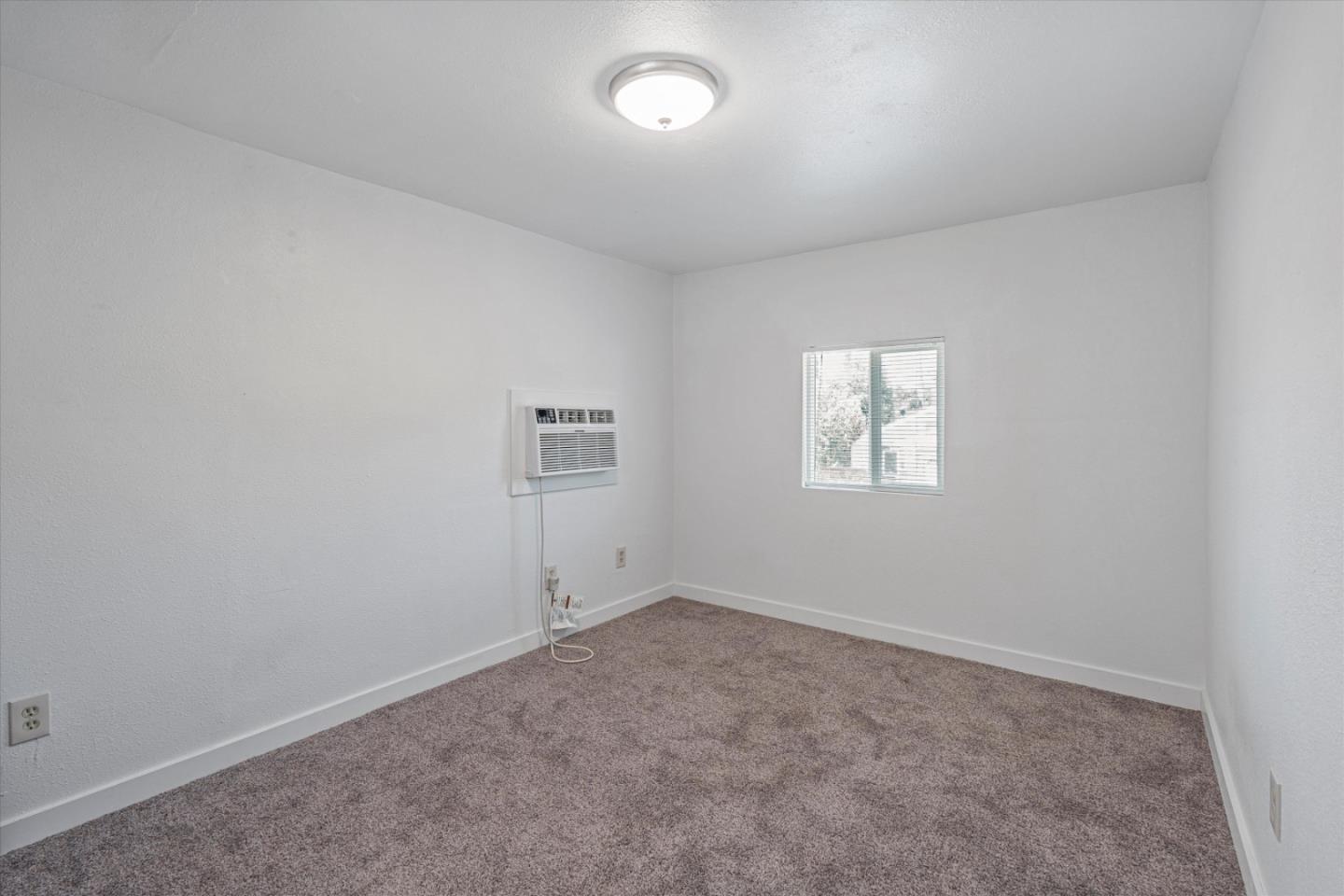 149 Covena Avenue Modesto, CA 95354 - Photo 16 of 24 an empty room with a empty space and windows