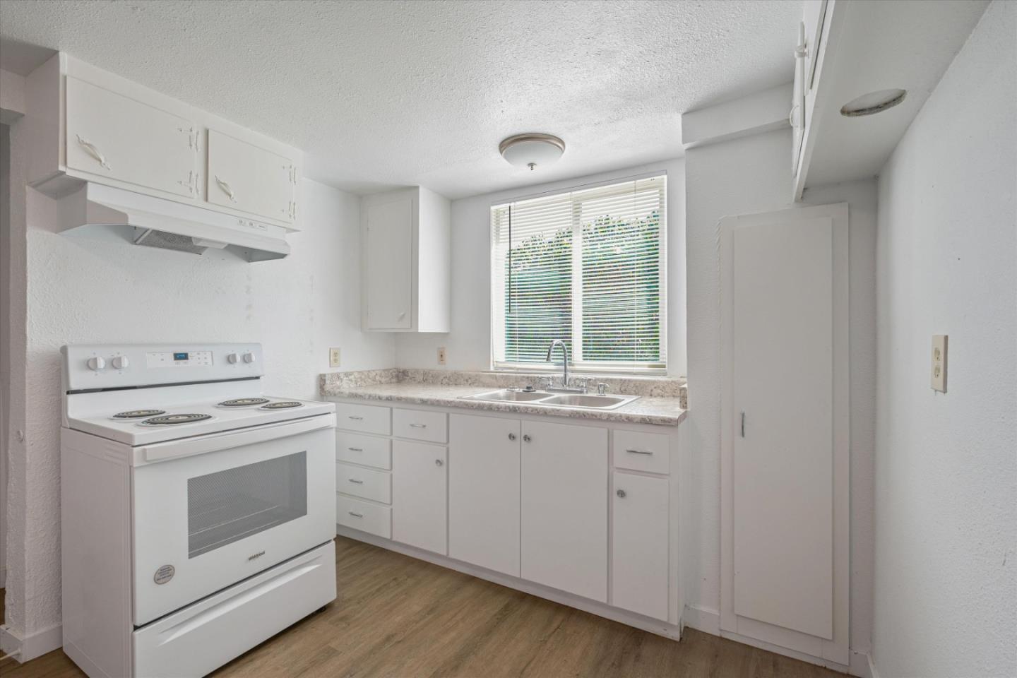 149 Covena Avenue Modesto, CA 95354 - Photo 18 of 24 a view of cabinets a sink and wooden floor