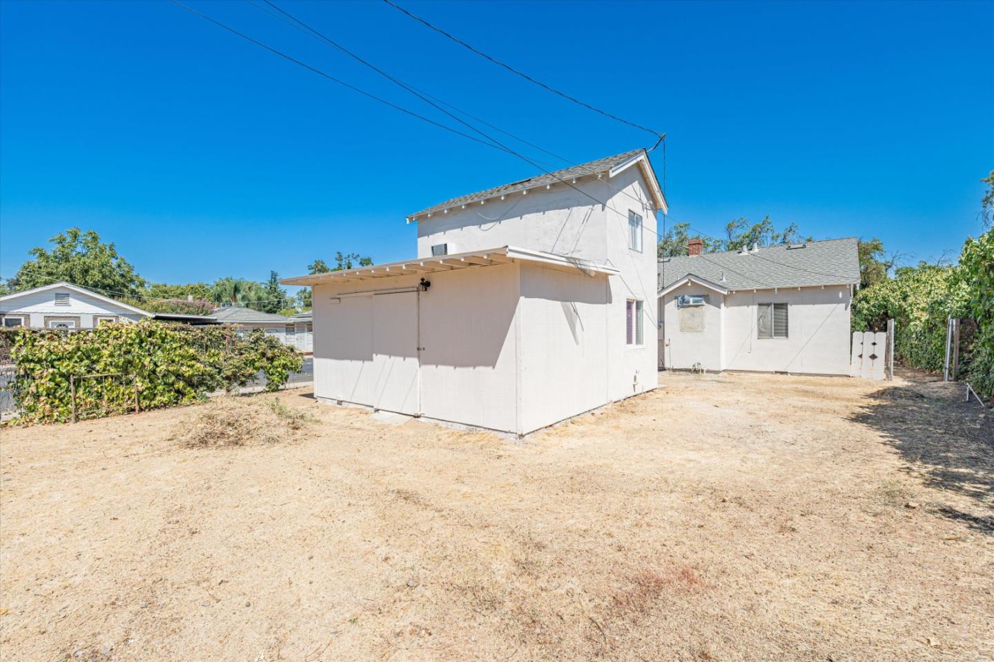 149 Covena Avenue Modesto, CA 95354 - Photo 22 of 24 a view of a house with a yard and garage