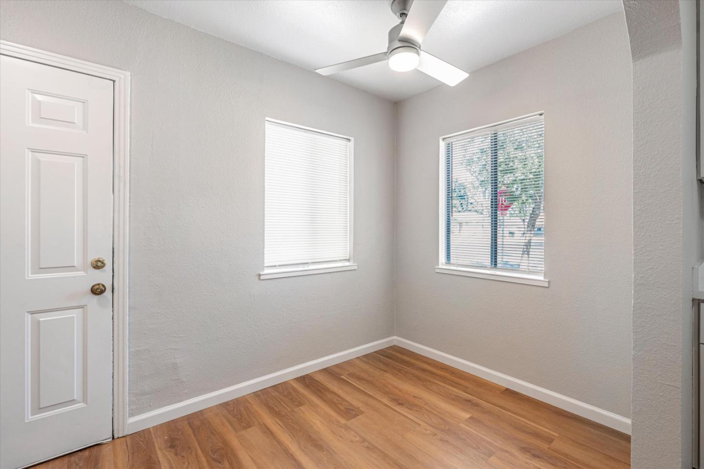 149 Covena Avenue Modesto, CA 95354 - Photo 3 of 24 wooden floor in an empty room with a window