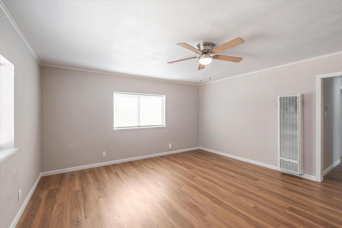 149 Covena Avenue Modesto, CA 95354 - Photo 5 of 24 wooden floor in an empty room with a window