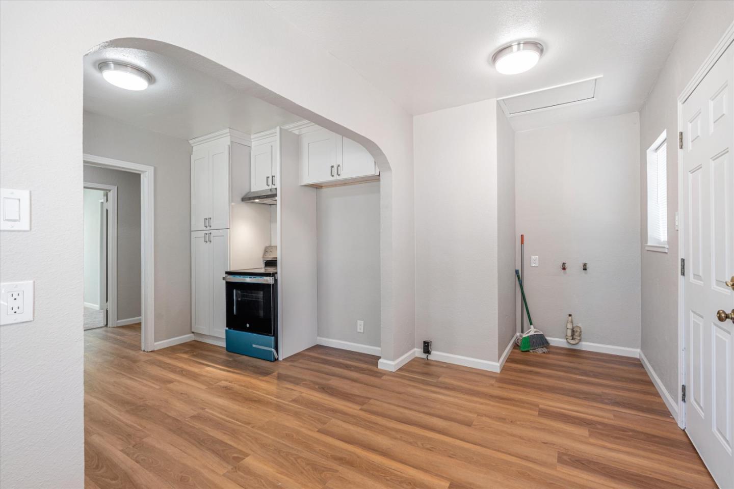149 Covena Avenue Modesto, CA 95354 - Photo 7 of 24 a view of a livingroom with wooden floor and a kitchen