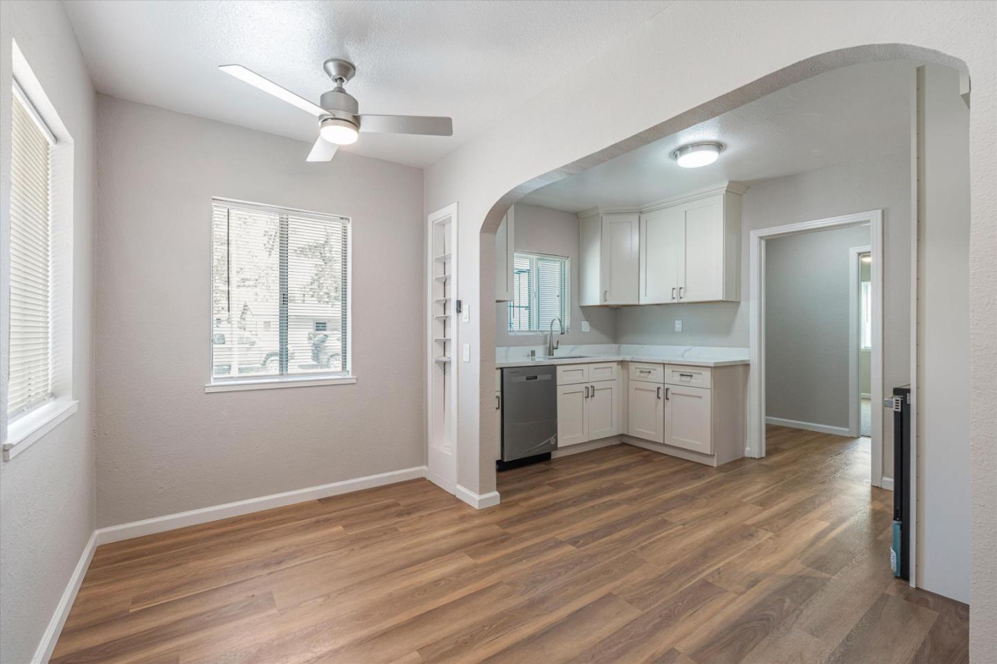 149 Covena Avenue Modesto, CA 95354 - Photo 8 of 24 a kitchen with stainless steel appliances granite countertop a sink cabinets and wooden floor