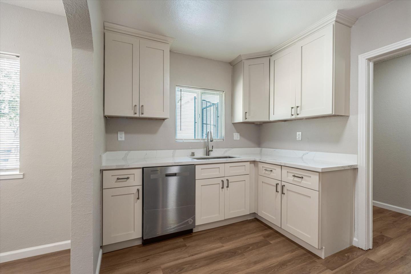 149 Covena Avenue Modesto, CA 95354 - Photo 9 of 24 a kitchen with stainless steel appliances granite countertop a sink and cabinets