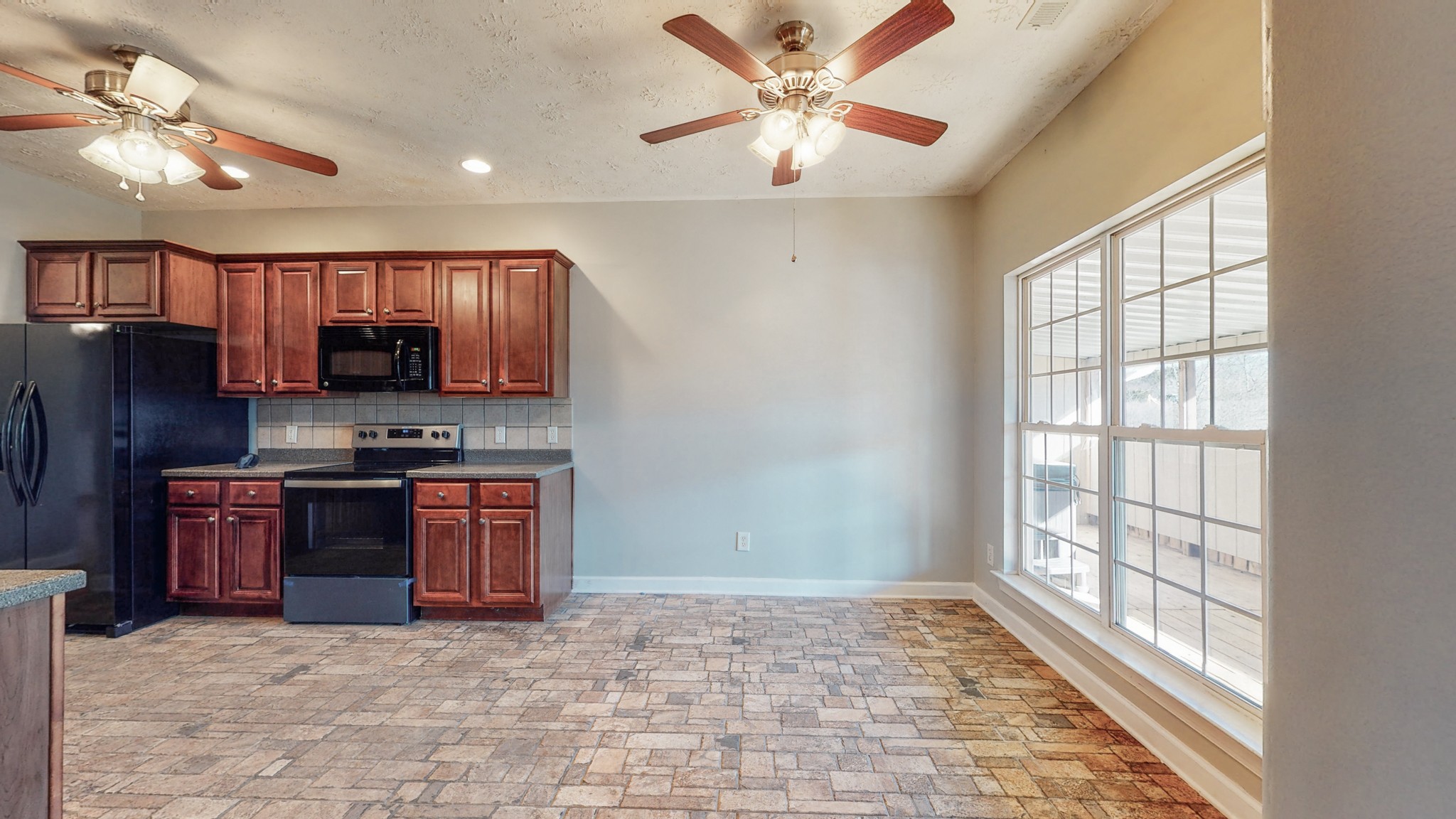 6023 Murfreesboro Road Lebanon, TN 37090 - Photo 12 of 42 a large kitchen with stainless steel appliances granite countertop a stove a refrigerator a sink dishwasher with a dining table and chairs