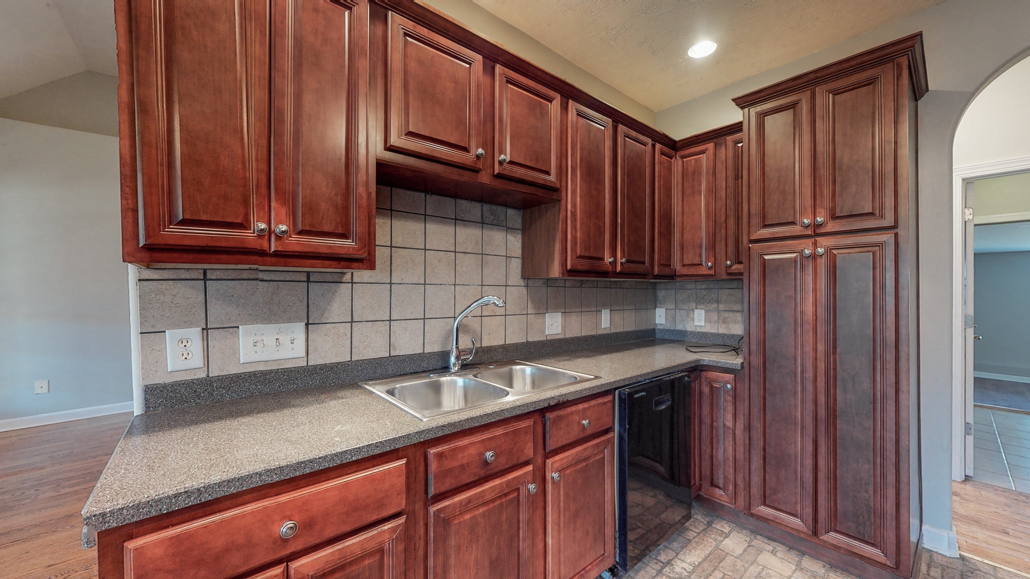 6023 Murfreesboro Road Lebanon, TN 37090 - Photo 14 of 42 a kitchen with wooden cabinets a sink and stainless steel appliances