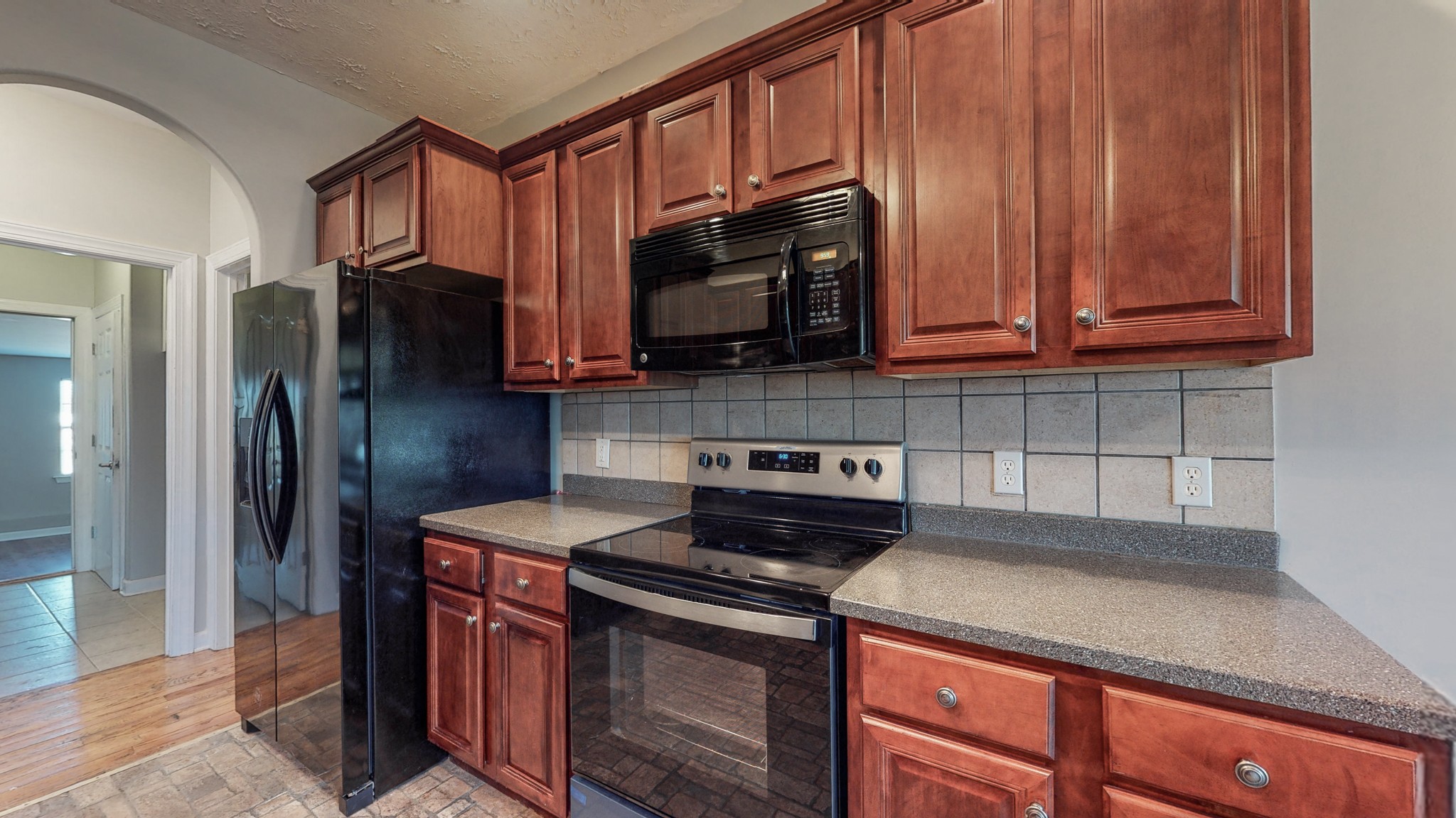 6023 Murfreesboro Road Lebanon, TN 37090 - Photo 15 of 42 a kitchen with stainless steel appliances granite countertop a refrigerator stove and cabinets