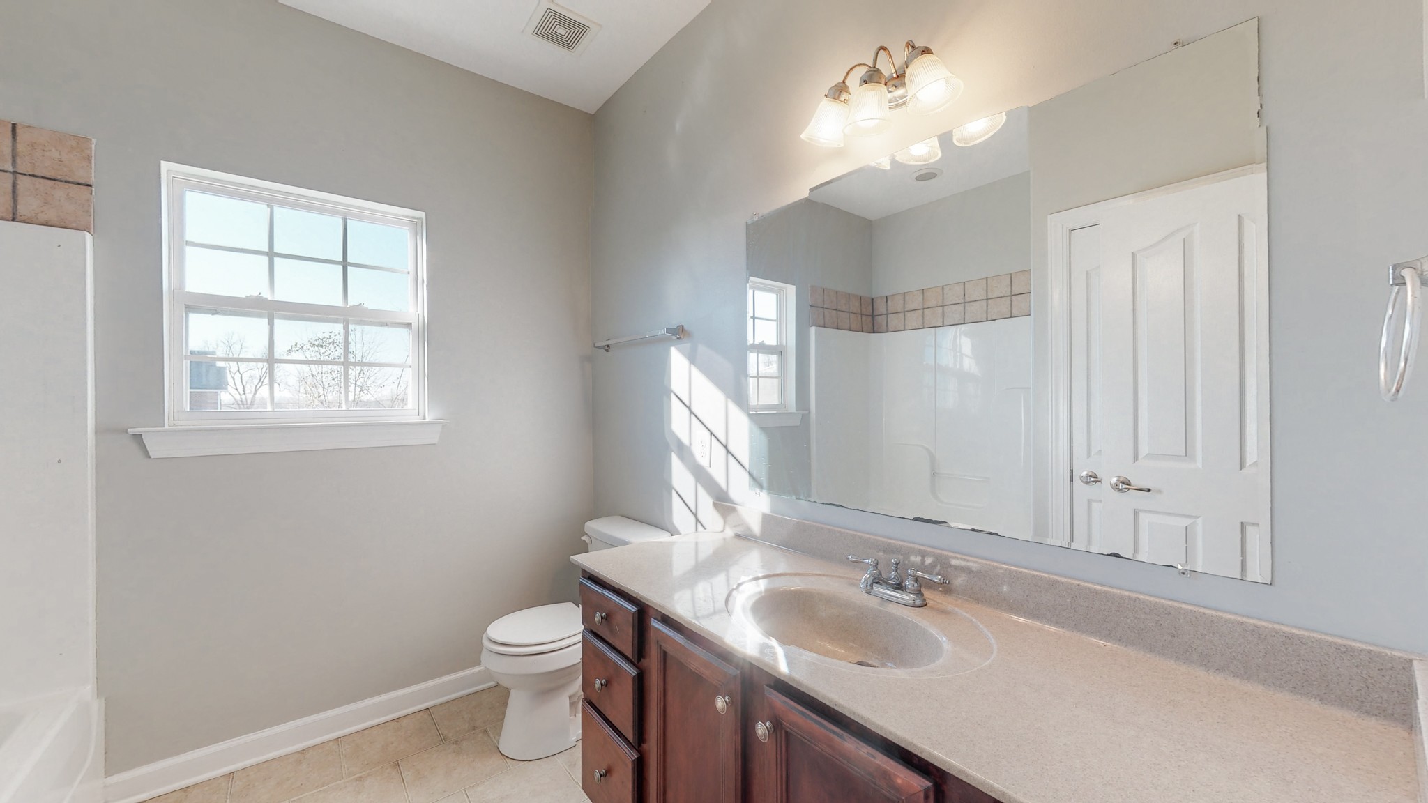 6023 Murfreesboro Road Lebanon, TN 37090 - Photo 27 of 42 a bathroom with a toilet a sink and mirror