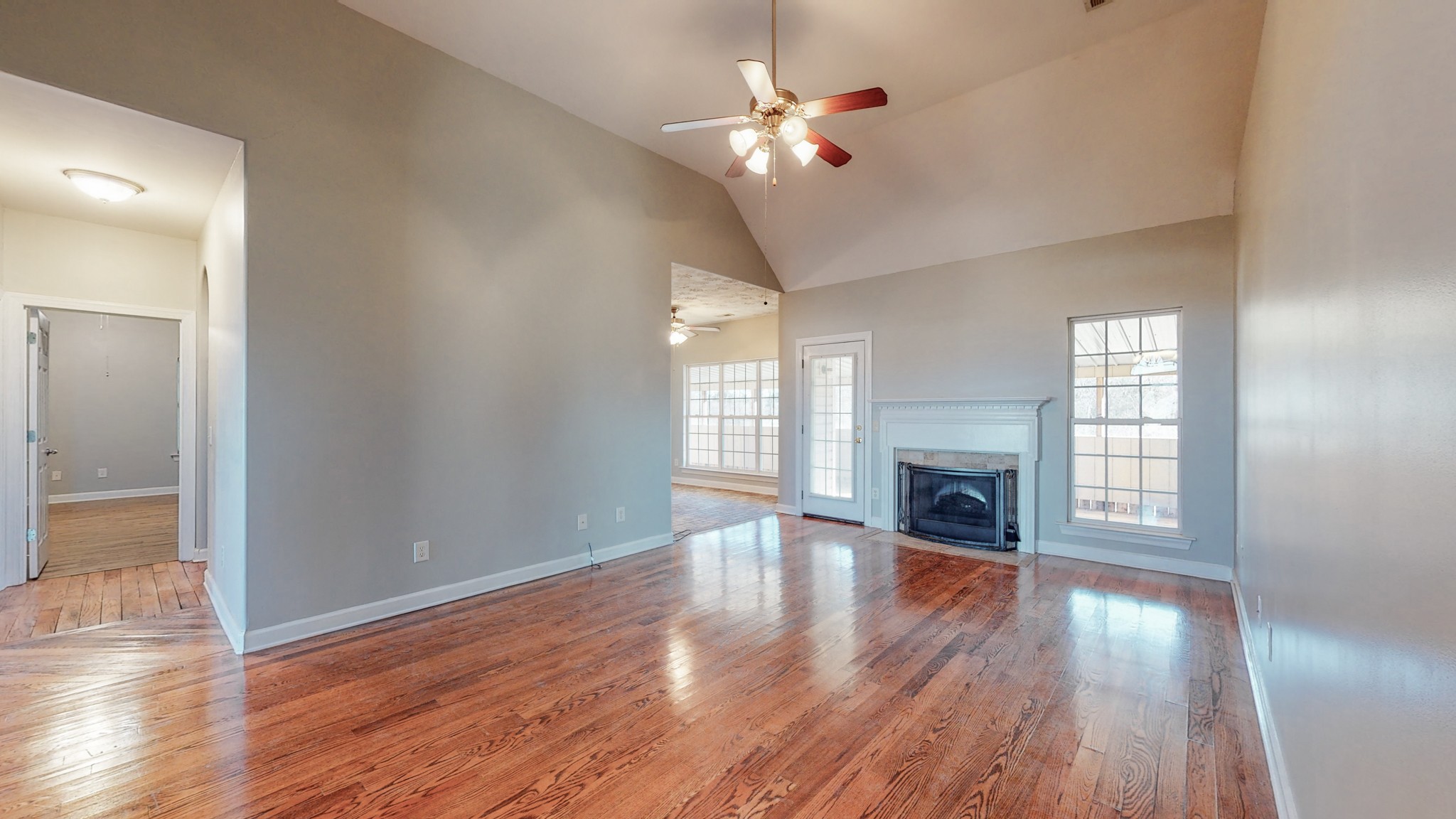 6023 Murfreesboro Road Lebanon, TN 37090 - Photo 9 of 42 an empty room with wooden floor fireplace and windows