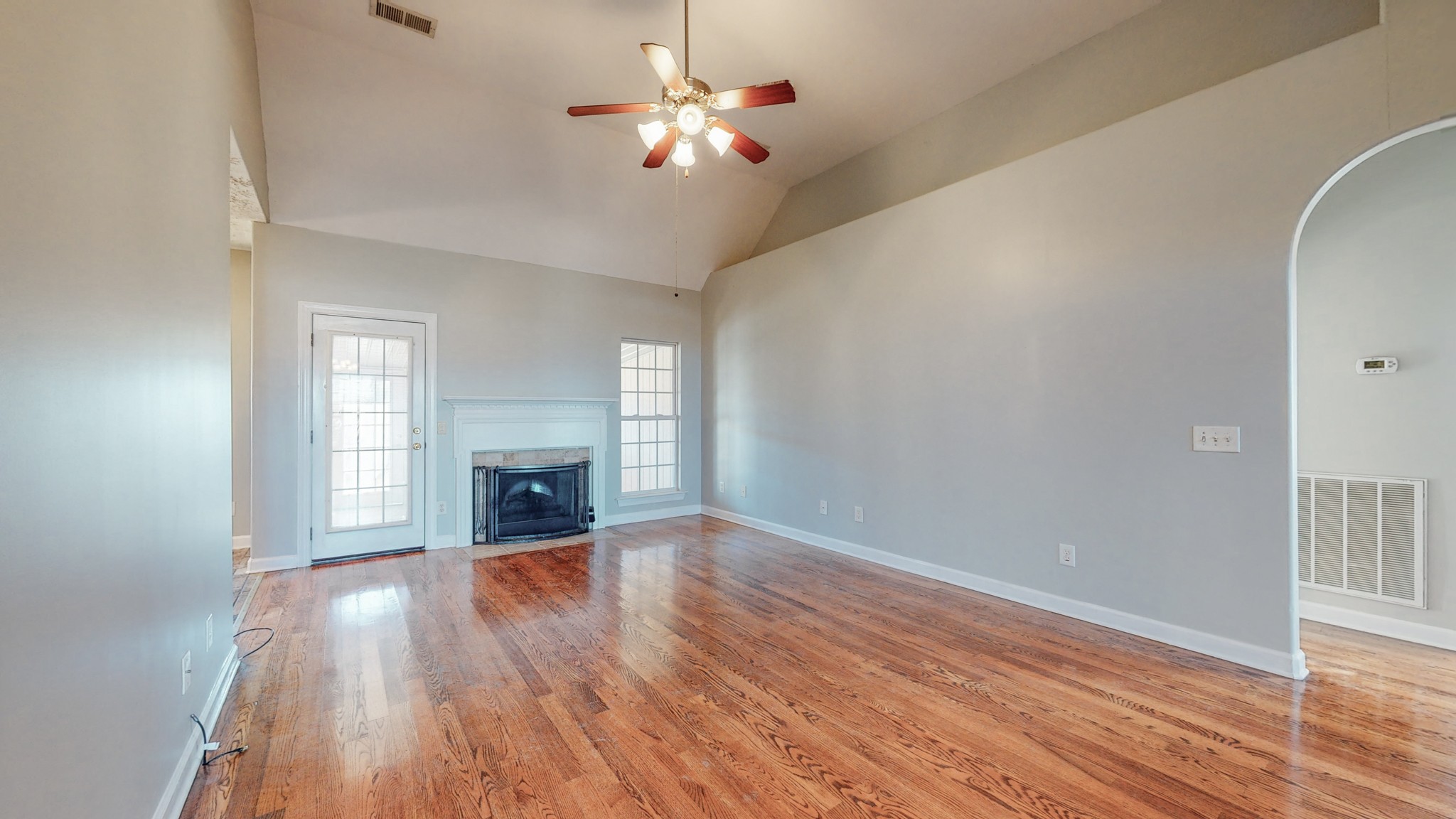 6023 Murfreesboro Road Lebanon, TN 37090 - Photo 10 of 42 wooden floor fireplace and windows in an empty room