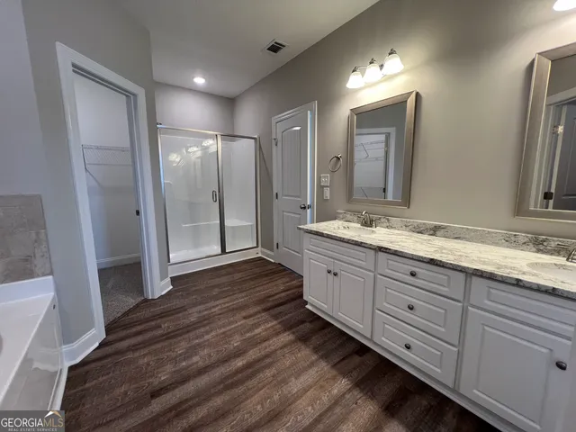 a bathroom with double vanity sink and a mirror
