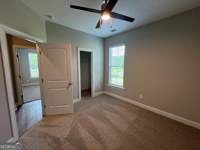 an empty room with closet and windows