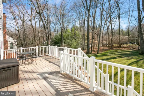 a view of a wooden deck and a yard with wooden fence