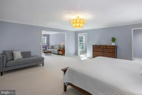 a bedroom with a bed and a couch